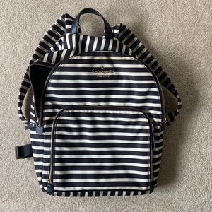Kate Spade black and white striped backpack with gold details.